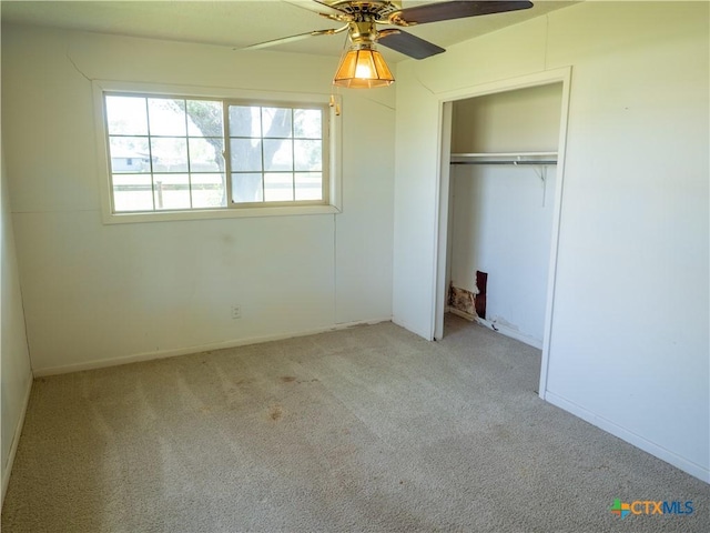 unfurnished bedroom with a closet, ceiling fan, carpet, and baseboards