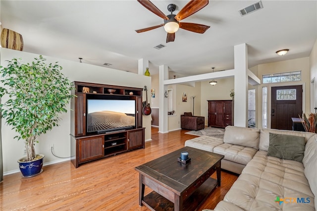 living area with baseboards, a ceiling fan, visible vents, and light wood-type flooring