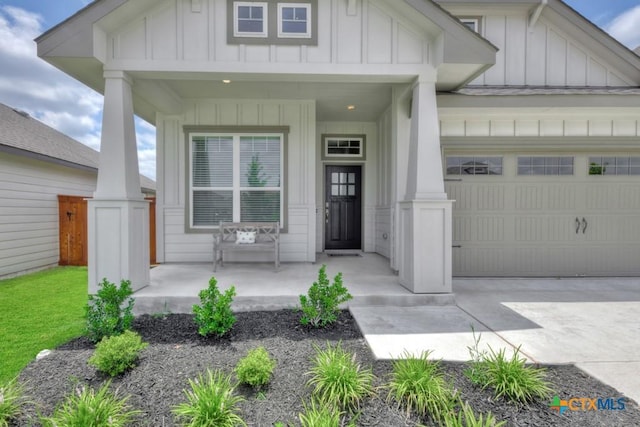 123 Paul Pena Dr, San Marcos, TX 78666 - view of front of property with board and batten siding, an attached garage, and a porch