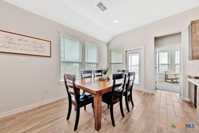 123 Paul Pena Dr, San Marcos, TX 78666 - dining space with light wood finished floors, vaulted ceiling, and baseboards