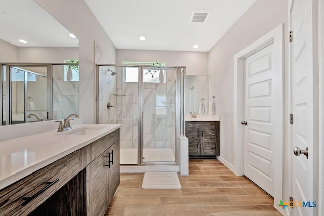 123 Paul Pena Dr, San Marcos, TX 78666 - full bath with vanity, a stall shower, recessed lighting, and wood finished floors