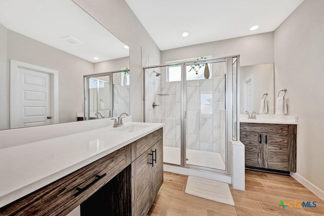 123 Paul Pena Dr, San Marcos, TX 78666 - bathroom with vanity, a stall shower, wood finished floors, baseboards, and recessed lighting