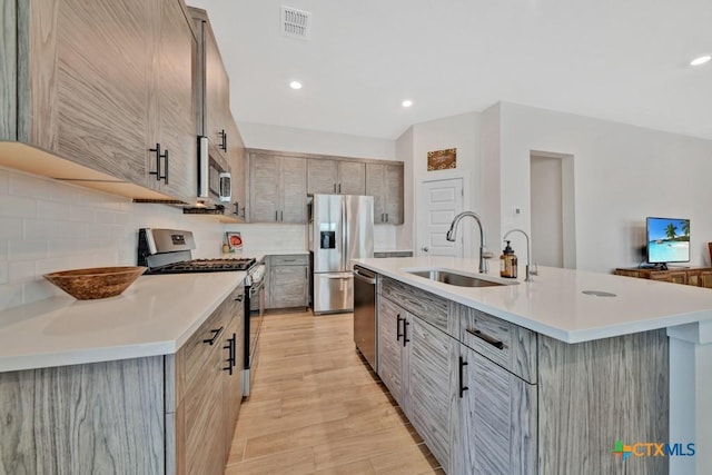 123 Paul Pena Dr, San Marcos, TX 78666 - kitchen with appliances with stainless steel finishes, a sink, gray cabinets, light countertops, and recessed lighting