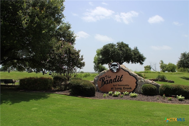 community / neighborhood sign with a yard