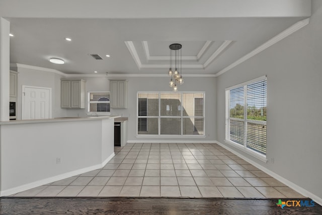 unfurnished living room with a notable chandelier, ornamental molding, a tray ceiling, and light tile patterned floors