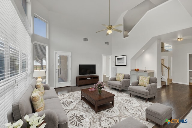 living room featuring hardwood / wood-style flooring, ceiling fan, and a wealth of natural light