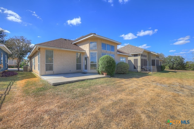 rear view of property with a yard, a patio area, and central air condition unit