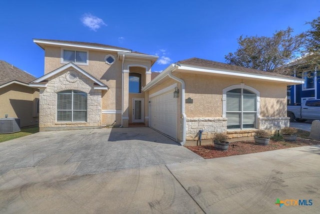 view of front of home with a garage and central AC