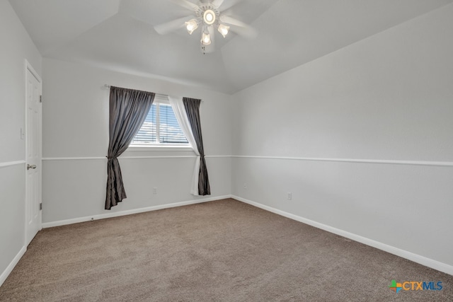 carpeted spare room featuring ceiling fan and lofted ceiling