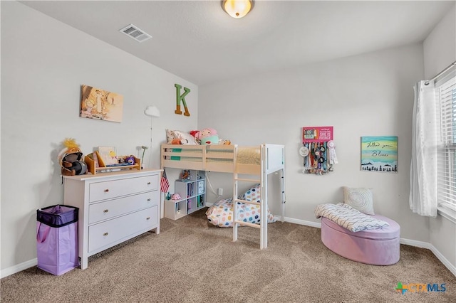 carpeted bedroom featuring baseboards and visible vents