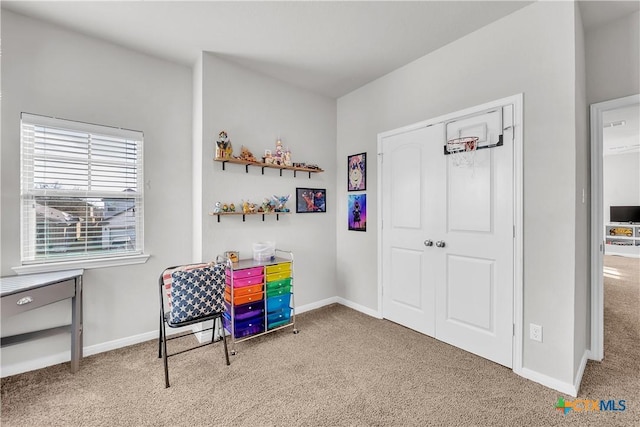 carpeted home office featuring baseboards