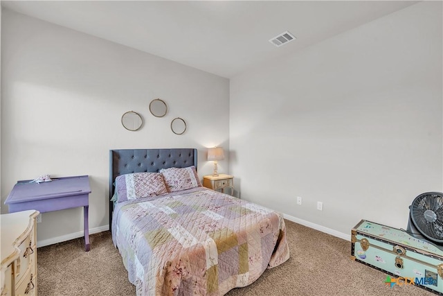 carpeted bedroom with visible vents and baseboards