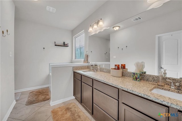 bathroom with tile patterned floors, double vanity, visible vents, and a sink