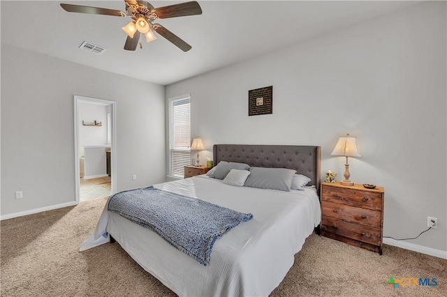 bedroom with visible vents, baseboards, carpet, ensuite bathroom, and a ceiling fan