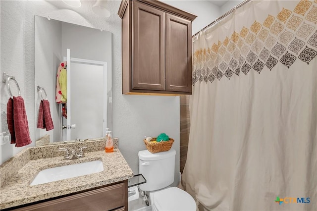 bathroom with vanity, toilet, and a shower with curtain