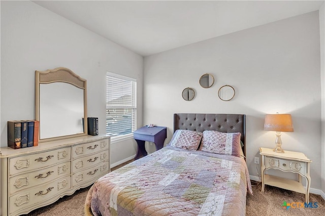 bedroom featuring carpet flooring and baseboards