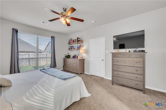 carpeted bedroom featuring visible vents, baseboards, and a ceiling fan