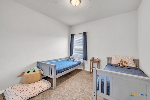 bedroom with carpet and baseboards