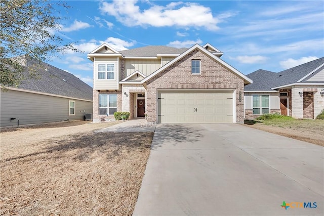 craftsman-style home with central AC unit, an attached garage, concrete driveway, board and batten siding, and brick siding