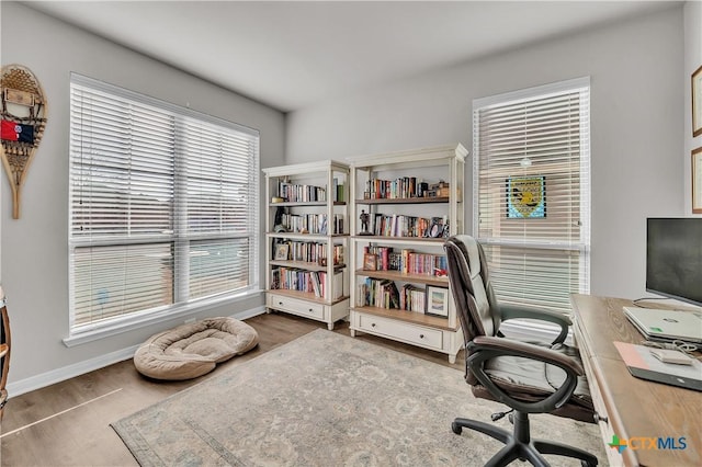 home office featuring baseboards and wood finished floors