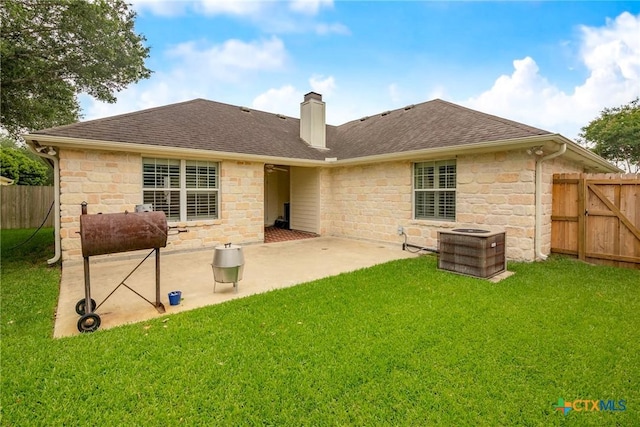 308 Green Gable Dr, Victoria, TX 77904 - back of house featuring stone siding, a chimney, roof with shingles, and a patio