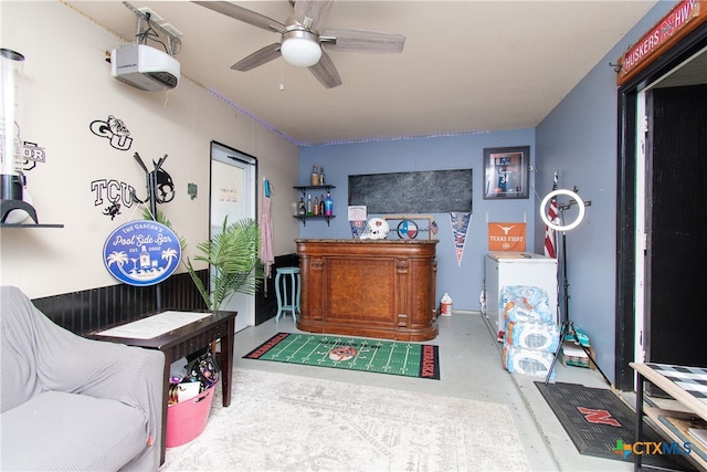 interior space with ceiling fan and concrete floors