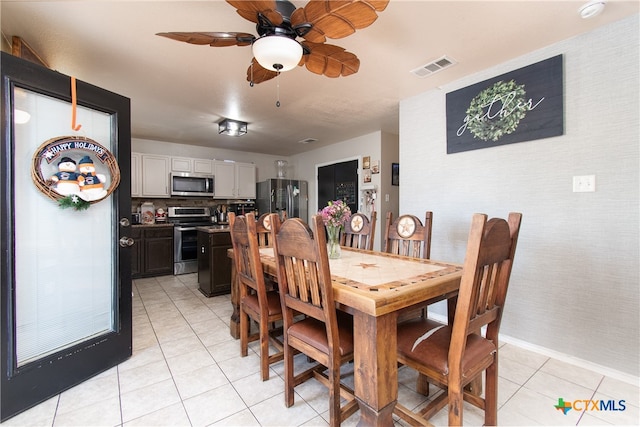 tiled dining area featuring ceiling fan