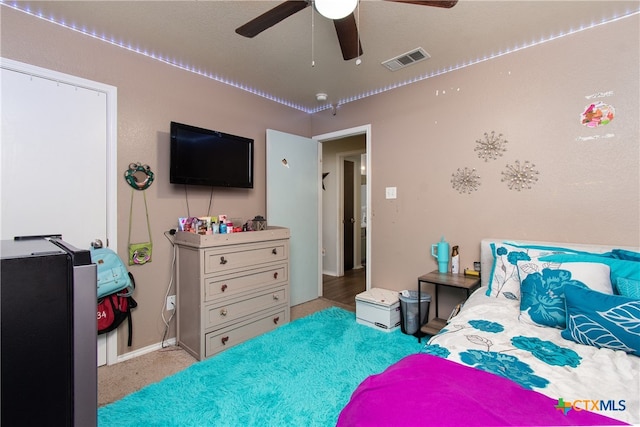 carpeted bedroom with ceiling fan