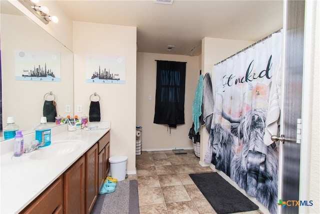 bathroom with tile patterned flooring and vanity