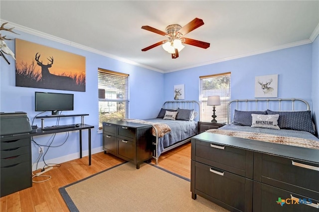 bedroom featuring light wood finished floors, ceiling fan, crown molding, and baseboards