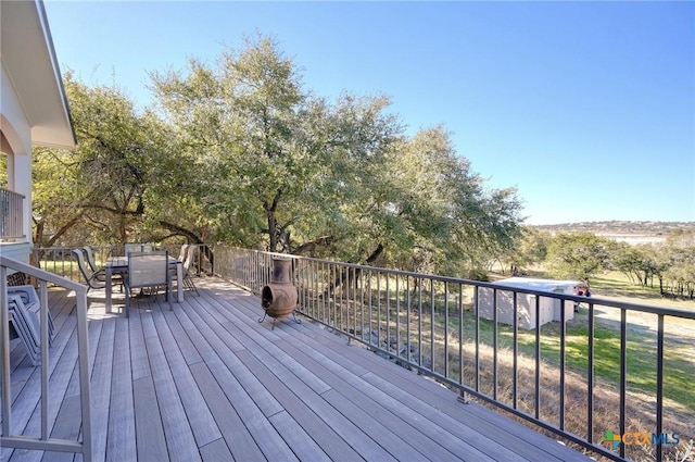 wooden terrace featuring outdoor dining area