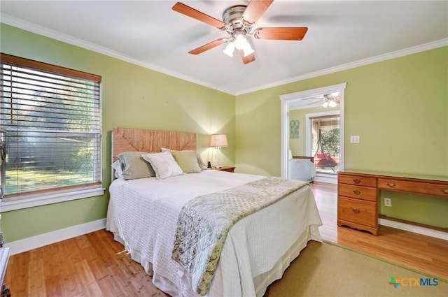 bedroom featuring wood finished floors, baseboards, and ornamental molding