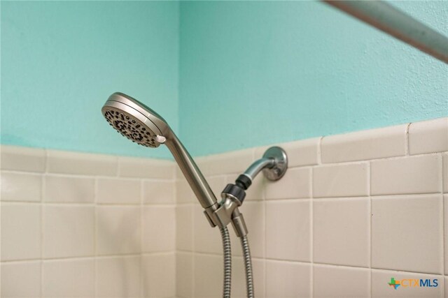 2102 Leon Dr, Port Lavaca, TX 77979 - bathroom view of tiled shower and a wainscoted wall