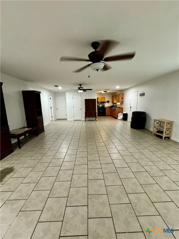 unfurnished living room with light tile patterned flooring and ceiling fan