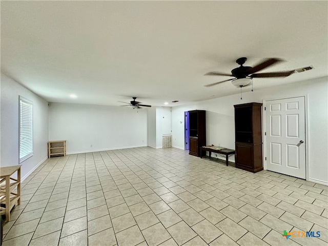 unfurnished living room with ceiling fan and light tile patterned floors