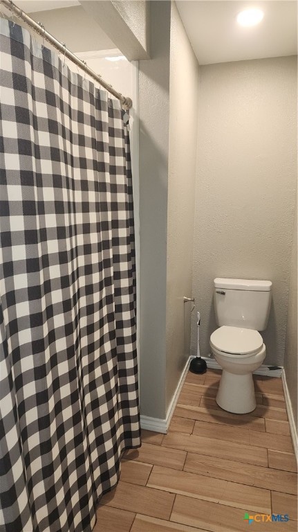 bathroom featuring toilet and hardwood / wood-style flooring