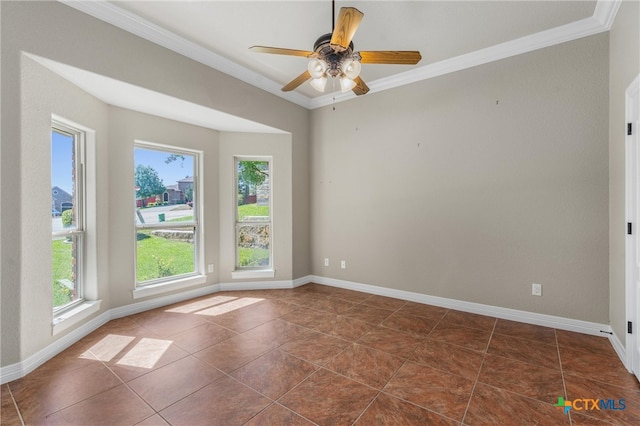 empty room featuring a ceiling fan, baseboards, dark tile patterned floors, and crown molding