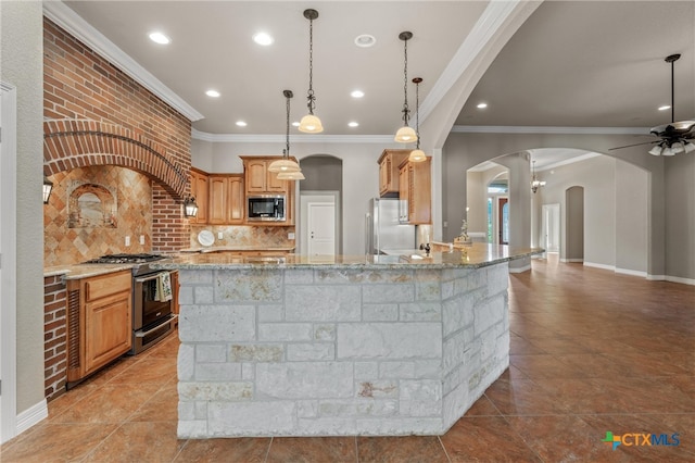 kitchen with ceiling fan, ornamental molding, light stone countertops, and stainless steel appliances