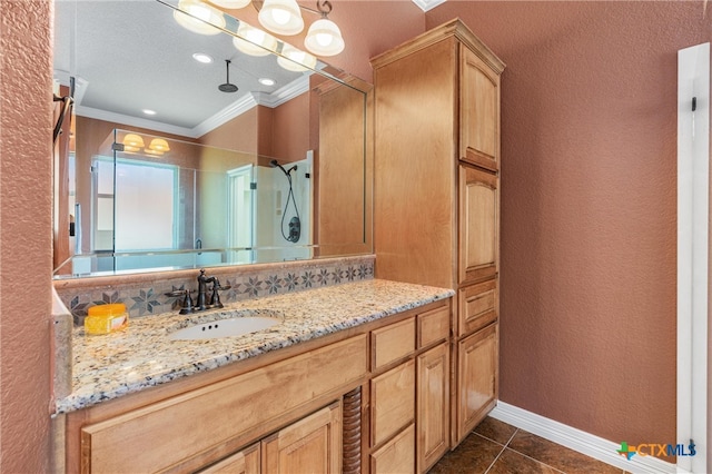 bathroom with crown molding, a stall shower, vanity, a textured wall, and tile patterned flooring