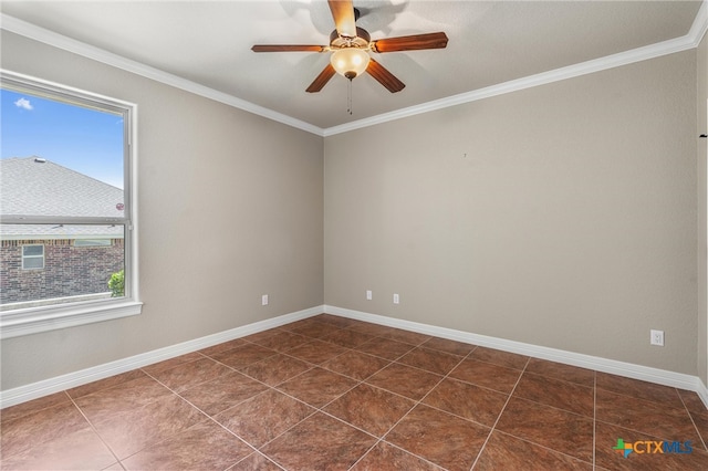 unfurnished room with dark tile patterned flooring, a wealth of natural light, ceiling fan, and crown molding