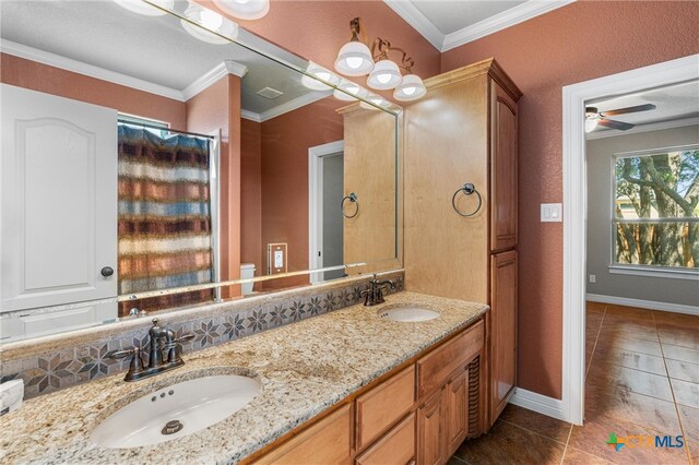 full bathroom with baseboards, tile patterned flooring, a sink, and double vanity