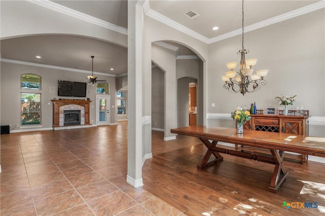 dining space with baseboards, visible vents, recessed lighting, crown molding, and a fireplace
