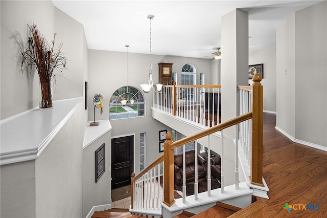 25039 Arrow Gln, San Antonio, TX 78258 - stairs with wood finished floors, baseboards, a chandelier, and a ceiling fan