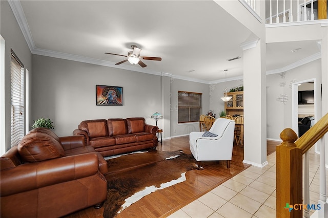 25039 Arrow Gln, San Antonio, TX 78258 - living area featuring ceiling fan, light tile patterned floors, crown molding, and baseboards