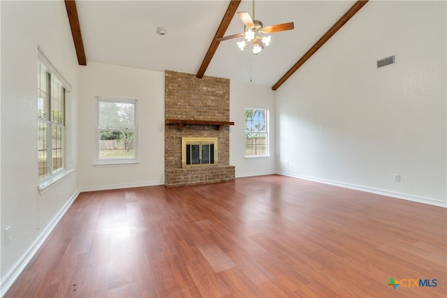 unfurnished living room featuring hardwood / wood-style flooring, a healthy amount of sunlight, and a fireplace