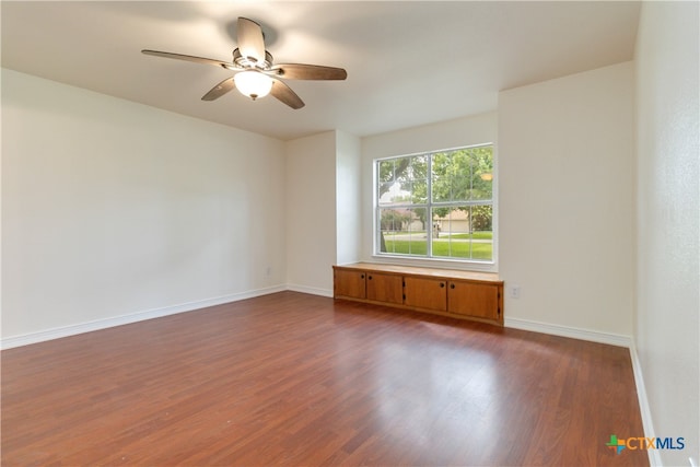 unfurnished room featuring ceiling fan and dark hardwood / wood-style floors