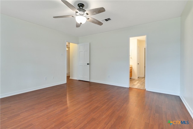 unfurnished room with ceiling fan and dark hardwood / wood-style floors