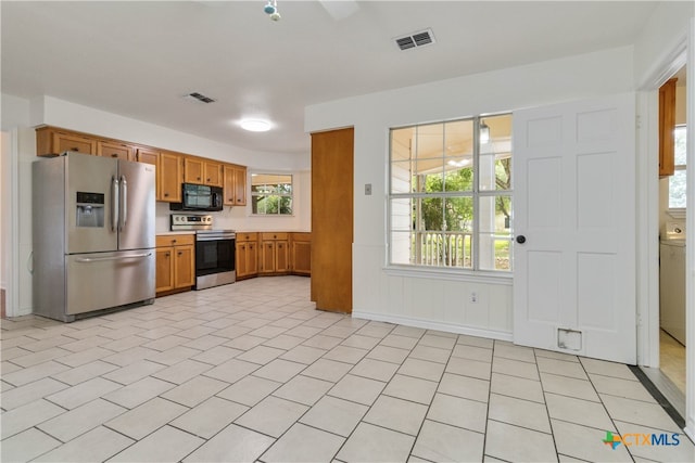 kitchen with stainless steel appliances and light tile patterned floors