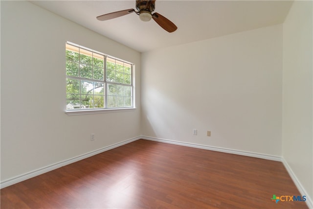 empty room featuring ceiling fan and dark hardwood / wood-style floors