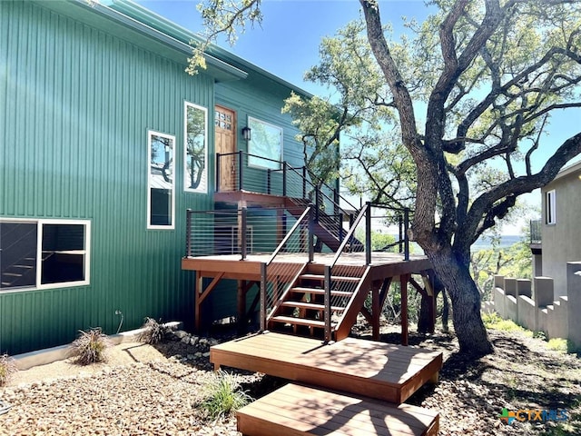 rear view of property featuring a wooden deck